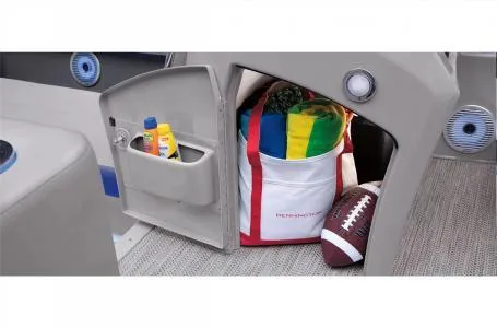 Slide: The Image of 2023 Bennington 23 LXSB storage compartment with beach bag, football, and sunscreen. - 12
