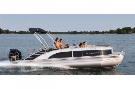 Slide: The Image of 2023 Bennington 23 LXSB pontoon boat cruising on a lake. - 16