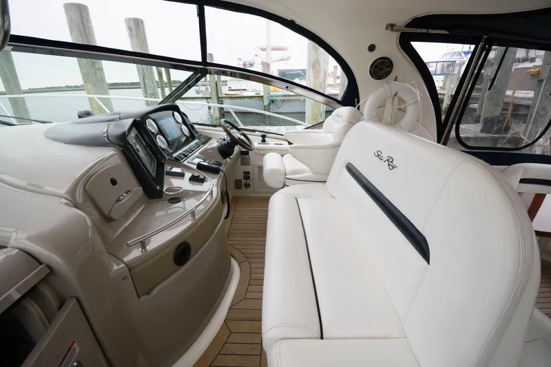 Slide: The Image of 2008 Sea Ray 44 Sundancer yacht interior with white leather seating and modern dashboard. - 11