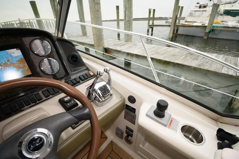 Slide: The Image of Helm of 2008 Sea Ray 44 Sundancer with navigation controls and dock view. - 13