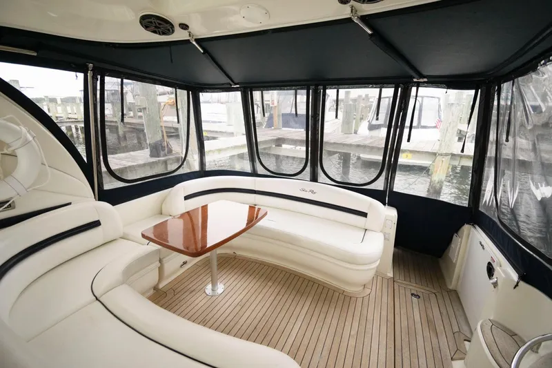 Slide: The Image of Interior of 2008 Sea Ray 44 Sundancer with white seating and wooden table. - 14