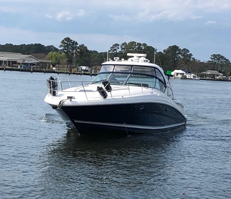 Slide: The Image of 2008 Sea Ray 44 Sundancer yacht cruising on a calm lake. - 2