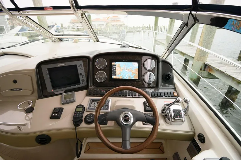 Slide: The Image of 2008 Sea Ray 44 Sundancer helm with navigation and control systems. - 24
