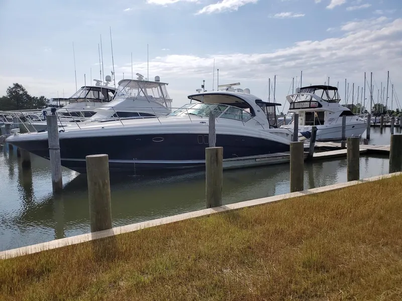 Slide: The Image of 2008 Sea Ray 44 Sundancer yacht docked at marina under partly cloudy sky. - 3