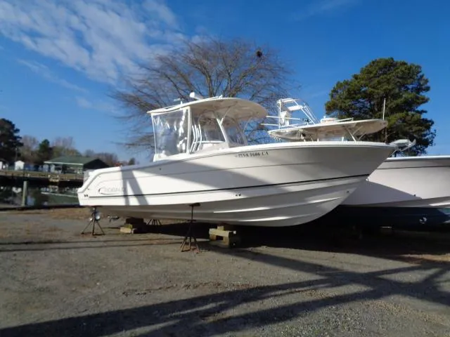 Slide: The Image of 2016 Robalo R300 Center Console boat on display outdoors. - 0