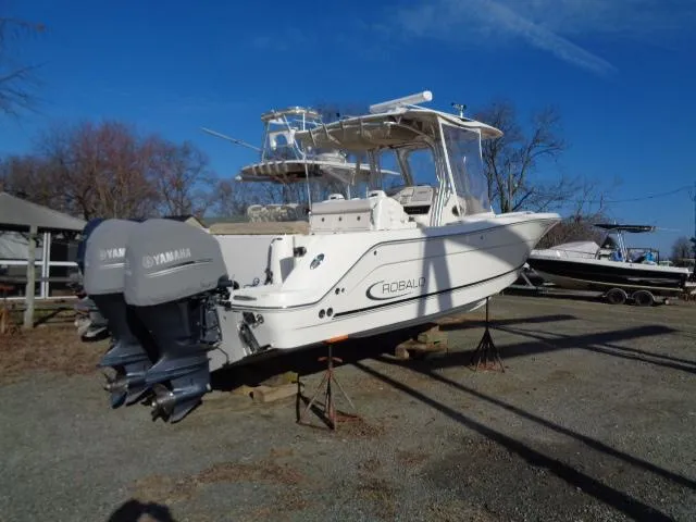 Slide: The Image of 2016 Robalo R300 Center Console boat with Yamaha engines on dry land. - 1