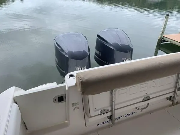 Slide: The Image of 2016 Robalo R300 Center Console with twin Yamaha 300 engines on calm water. - 13