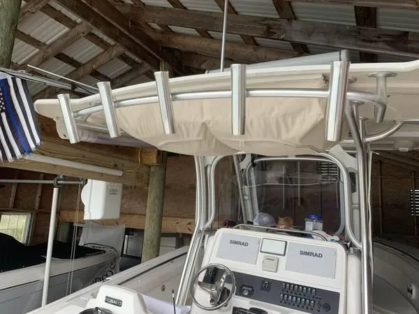 Slide: The Image of 2016 Robalo R300 Center Console boat in a wooden boathouse. - 14