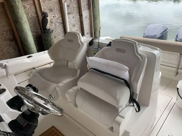 Slide: The Image of 2016 Robalo R300 Center Console boat interior with dual helm seats. - 17