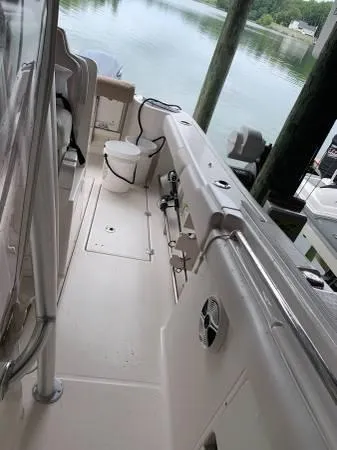 Slide: The Image of 2016 Robalo R300 Center Console boat docked by calm waters. - 2