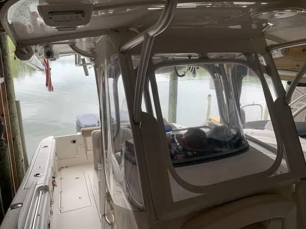 Slide: The Image of 2016 Robalo R300 Center Console boat docked in a marina. - 20