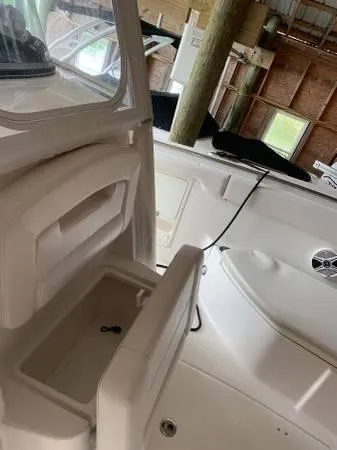 Slide: The Image of 2016 Robalo R300 Center Console interior with storage compartment and seating. - 22