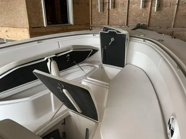 Slide: The Image of 2016 Robalo R300 Center Console boat interior with open storage compartments. - 23