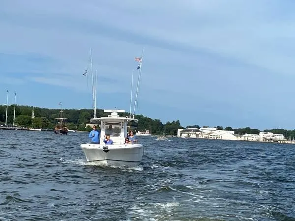 Slide: The Image of 2016 Robalo R300 Center Console boat cruising on a scenic waterway. - 3