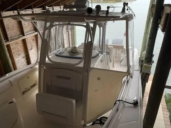 Slide: The Image of 2016 Robalo R300 Center Console boat docked in a covered slip. - 4