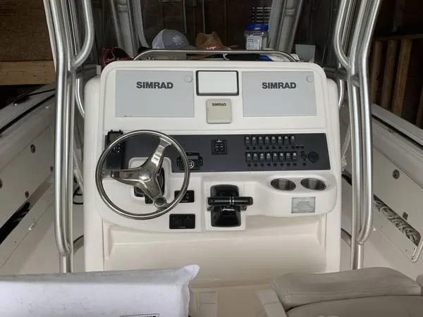 Slide: The Image of 2016 Robalo R300 Center Console boat dashboard with Simrad electronics. - 7
