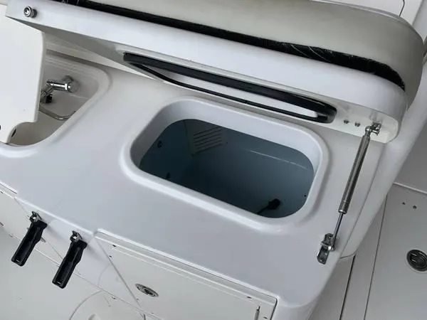 Slide: The Image of 2016 Robalo R300 Center Console boat storage compartment and seating area. - 9