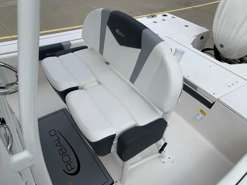 Slide: The Image of 2024 Robalo 246 Cayman SD boat with cushioned seating and branded floor mat. - 10