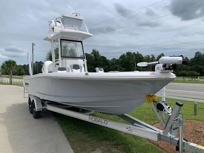 Slide: The Image of 2024 Robalo 246 Cayman SD boat on trailer, side view. - 2