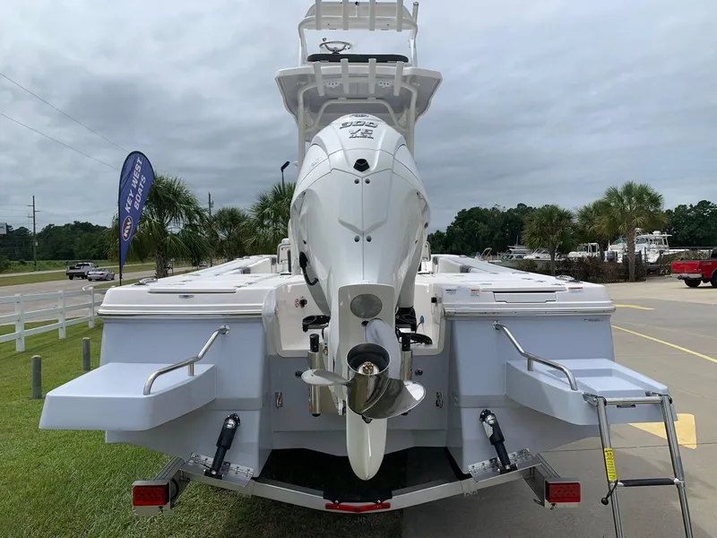 Slide: The Image of 2024 Robalo 246 Cayman SD boat rear view with outboard motor and swim platforms. - 3