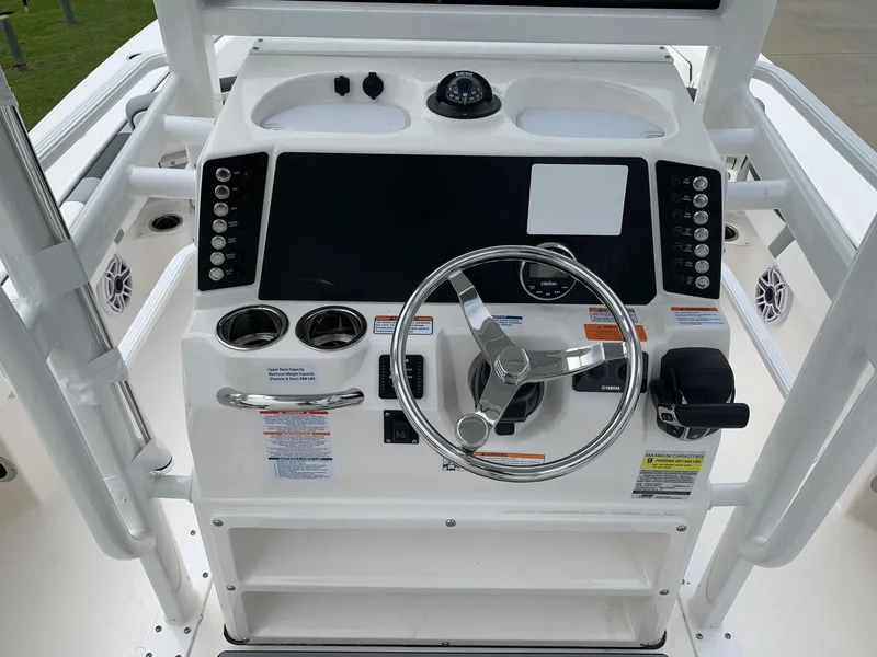 Slide: The Image of 2024 Robalo 246 Cayman SD boat console with steering wheel and control panel. - 8