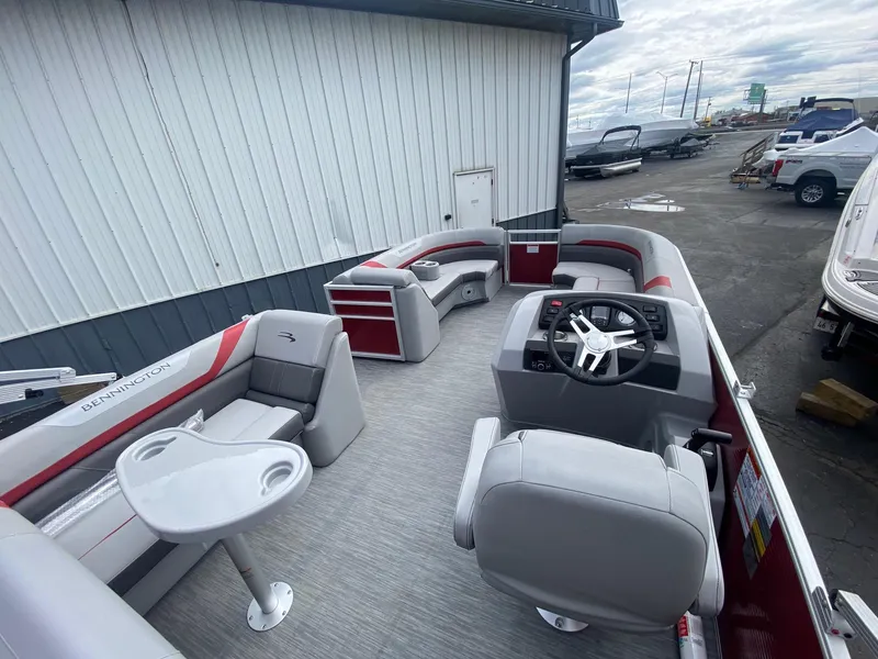 Slide: The Image of 2023 Bennington 21 SXSB pontoon boat with spacious seating and modern helm. - 9