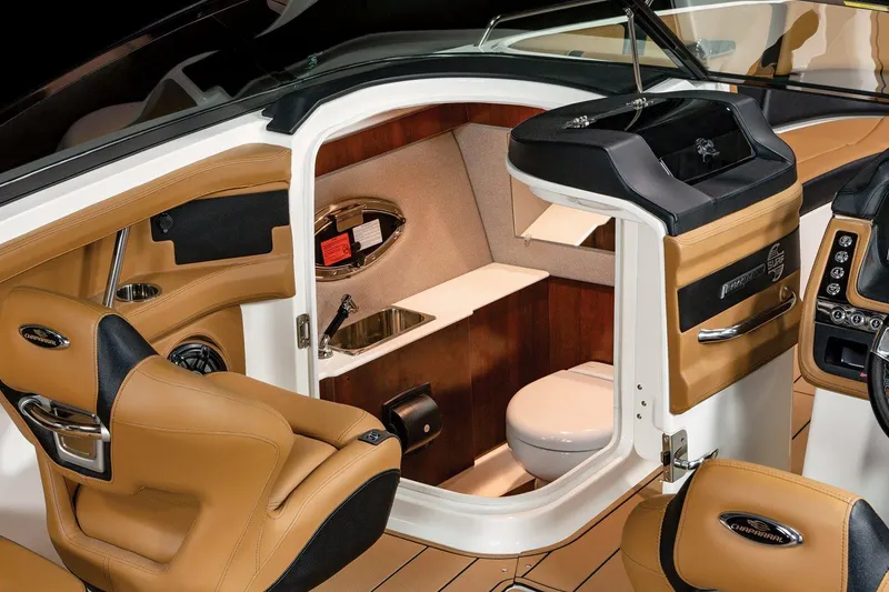 Slide: The Image of 2024 Chaparral 287 SSX boat interior with luxurious seating and compact restroom. - 6