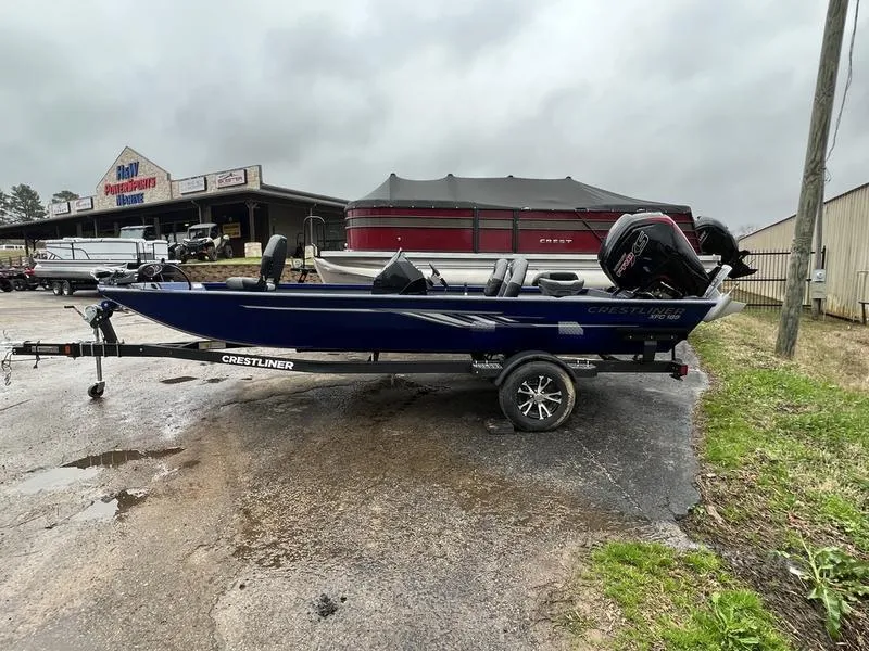 The Image of 2023 Crestliner XFC 189 fishing boat on trailer in dealership lot. - 1