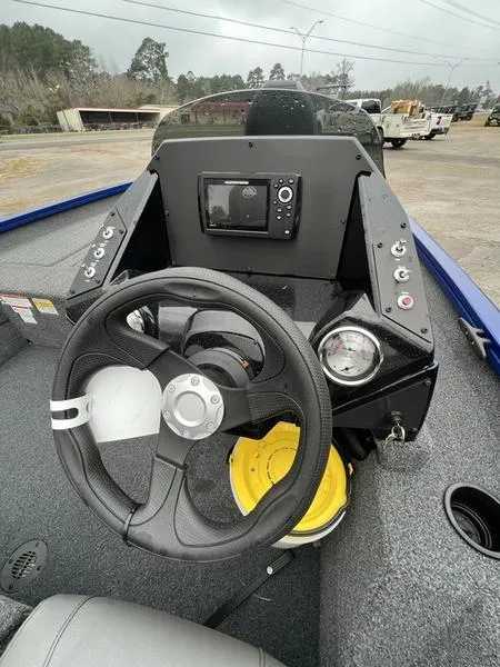 Slide: The Image of 2023 Crestliner XFC 189 boat dashboard with steering wheel and control panel. - 6