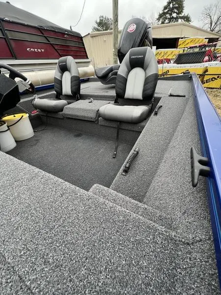 Slide: The Image of 2023 Crestliner XFC 189 fishing boat interior with dual seats and storage compartments. - 8
