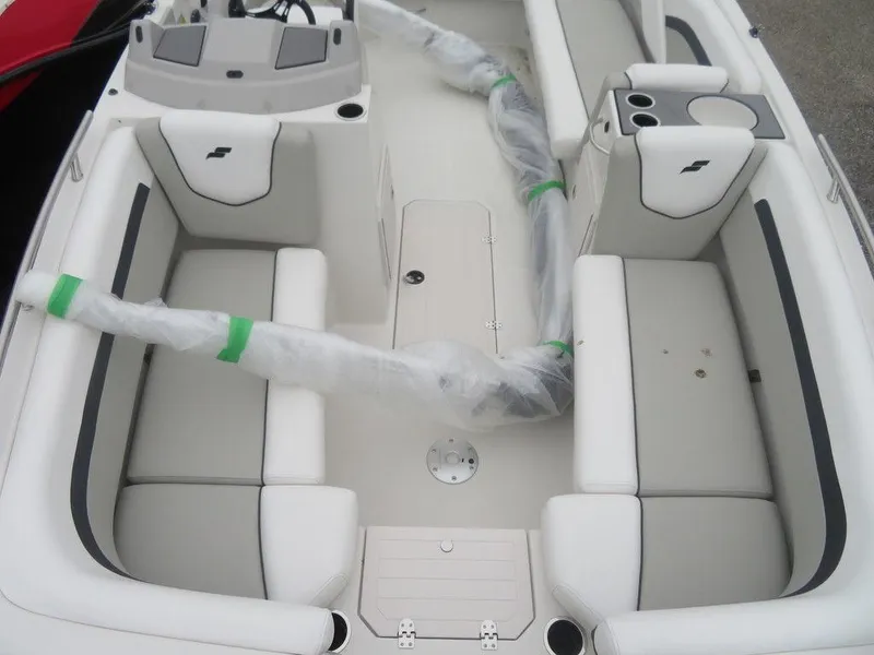 Slide: The Image of 2023 Starcraft SVX 211 OB boat interior with white seating and wrapped components. - 10