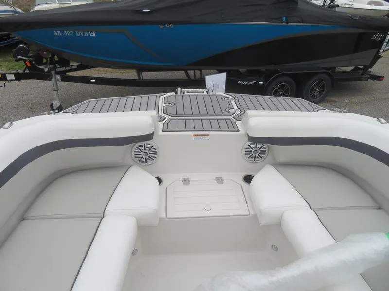 Slide: The Image of 2023 Starcraft SVX 211 OB boat interior with cushioned seating and speakers. - 11