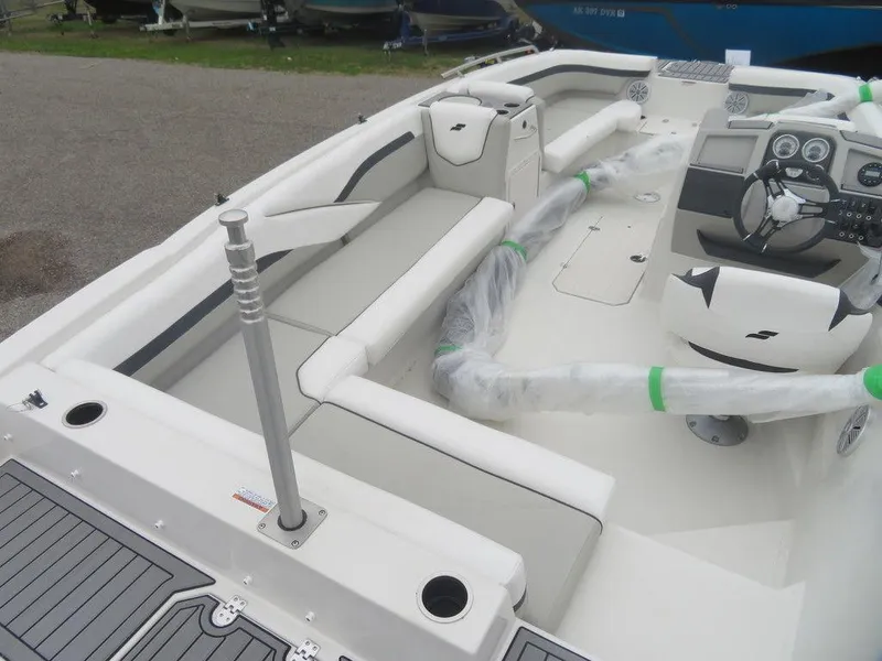Slide: The Image of 2023 Starcraft SVX 211 OB boat interior with white seating and modern dashboard. - 12