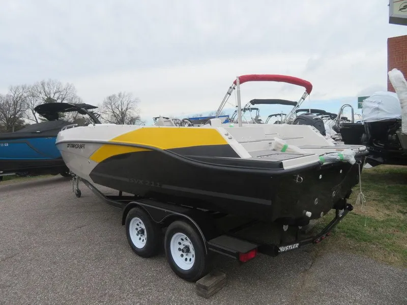 Slide: The Image of 2023 Starcraft SVX 211 OB boat on trailer, rear view with yellow and black accents. - 14