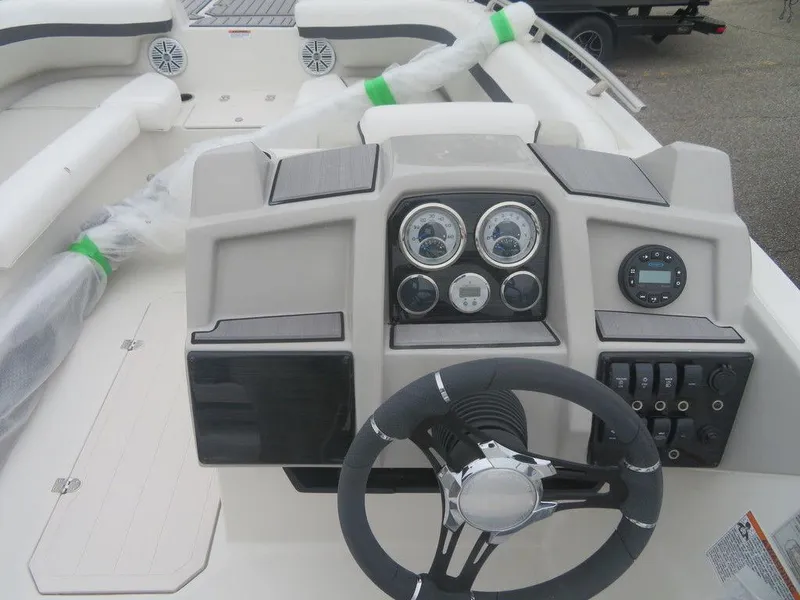 Slide: The Image of 2023 Starcraft SVX 211 OB boat dashboard with steering wheel and gauges. - 2