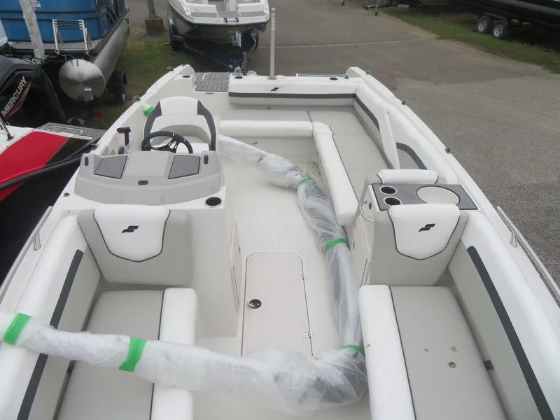 Slide: The Image of 2023 Starcraft SVX 211 OB boat interior with white seating and steering console. - 3