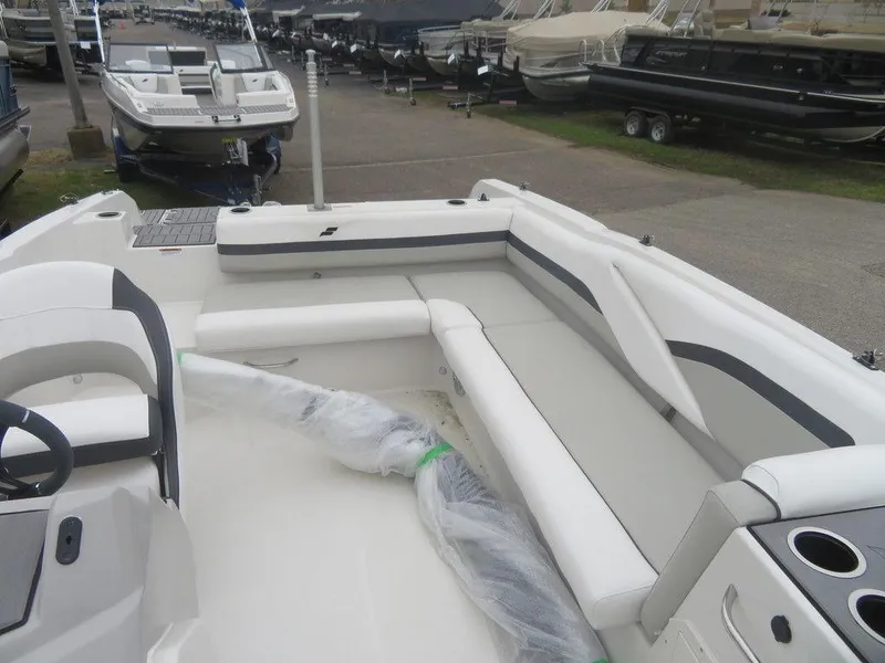 Slide: The Image of 2023 Starcraft SVX 211 OB boat interior with white seating and cup holders. - 8