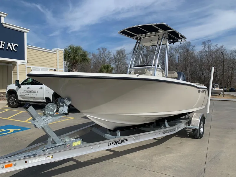 Slide: The Image of 2024 Key West 203 FS boat on a trailer in a parking lot. - 1