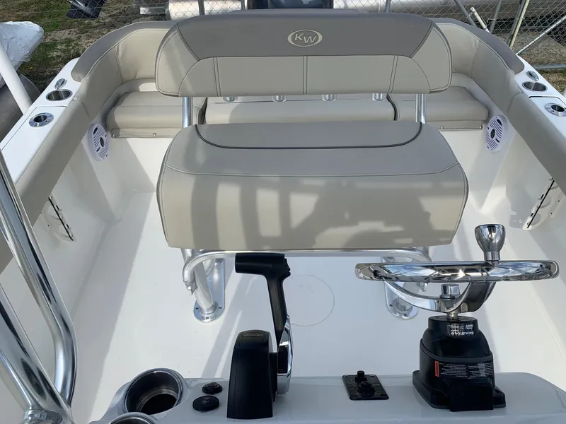 Slide: The Image of 2024 Key West 203 FS boat interior with steering wheel and seating. - 11