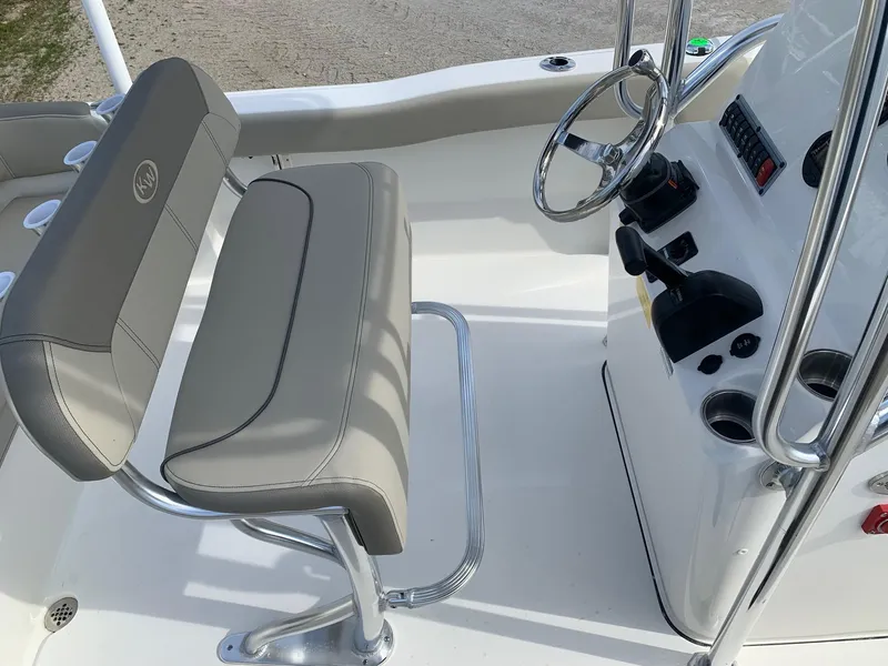 Slide: The Image of 2024 Key West 203 FS boat interior with steering console and seating. - 12