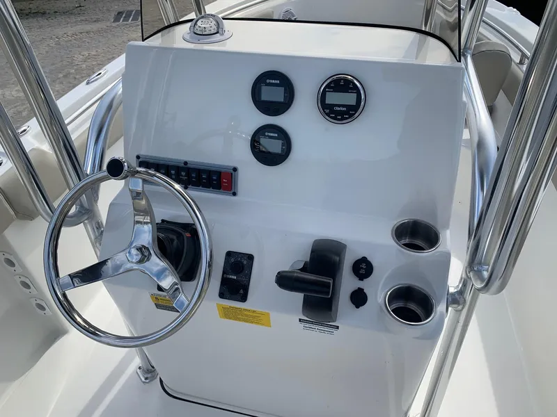 Slide: The Image of 2024 Key West 203 FS boat console with steering wheel and control panel. - 13