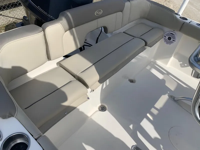 Slide: The Image of 2024 Key West 203 FS boat interior with beige seating and cup holders. - 16