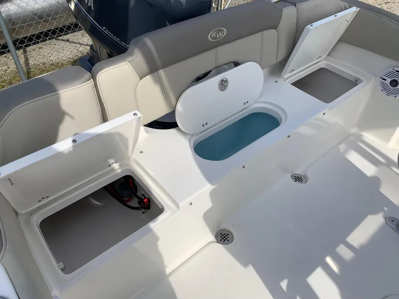 Slide: The Image of 2024 Key West 203 FS boat with open storage compartments and seating area. - 17