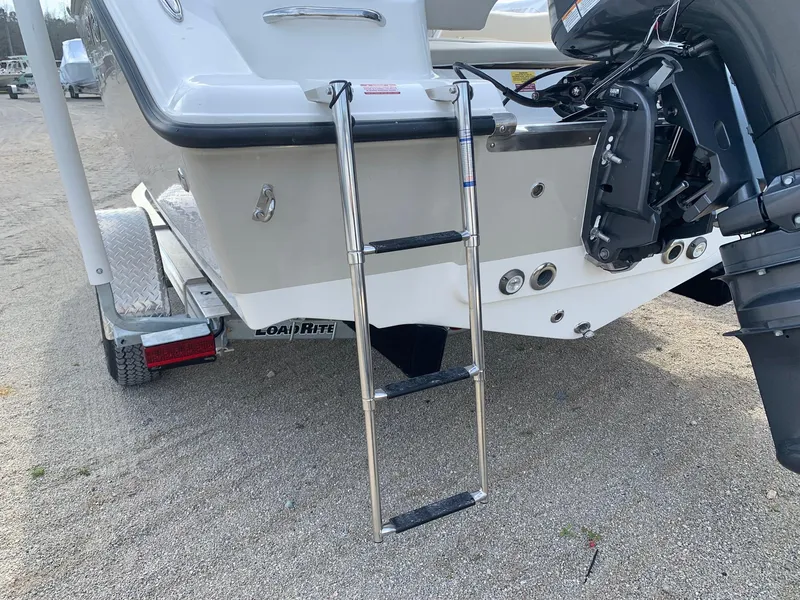 Slide: The Image of 2024 Key West 203 FS boat with ladder and outboard motor on trailer. - 4