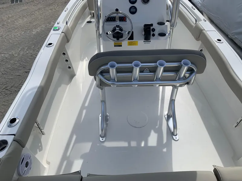 Slide: The Image of 2024 Key West 203 FS boat interior with steering console and rod holders. - 5