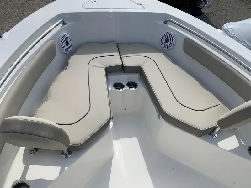 Slide: The Image of 2024 Key West 203 FS boat with cushioned seating and built-in cup holders. - 6