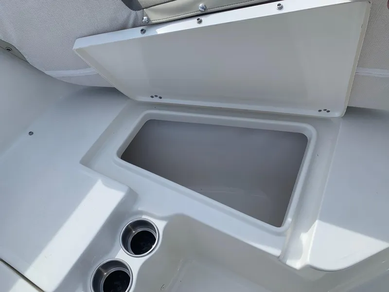 Slide: The Image of 2024 Key West 203 FS boat storage compartment with cup holders. - 7
