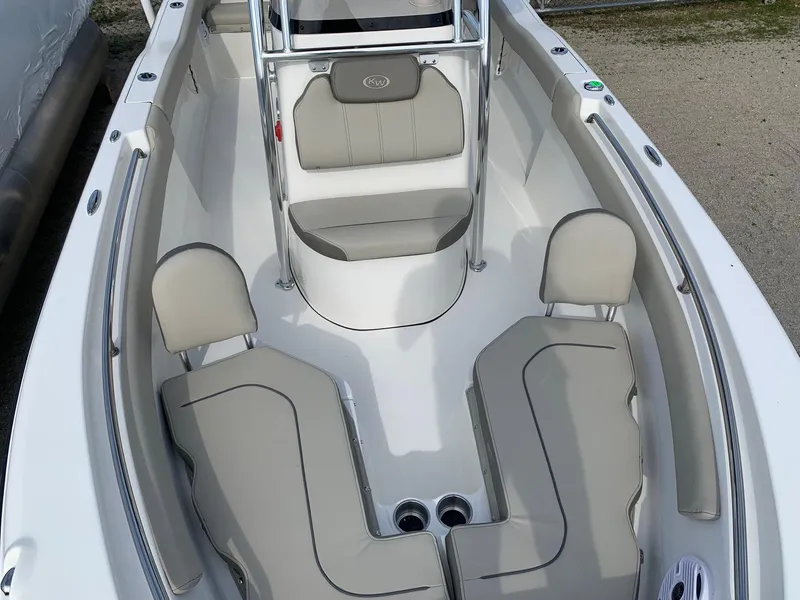 Slide: The Image of 2024 Key West 203 FS boat interior with gray seating and white deck. - 8