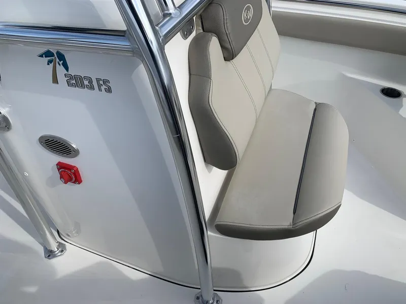 Slide: The Image of 2024 Key West 203 FS boat interior with cushioned seating and logo. - 9
