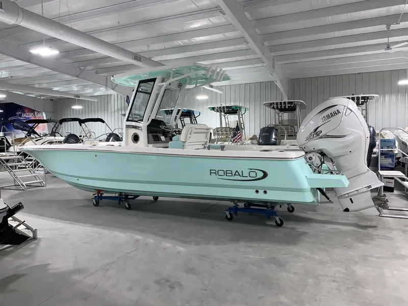 The Image of 2026 Robalo 266 Cayman boat in showroom, featuring Yamaha outboard motor. - 0